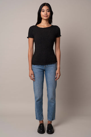 Model is wearing the Short Sleeve Crinkle Top in Black.