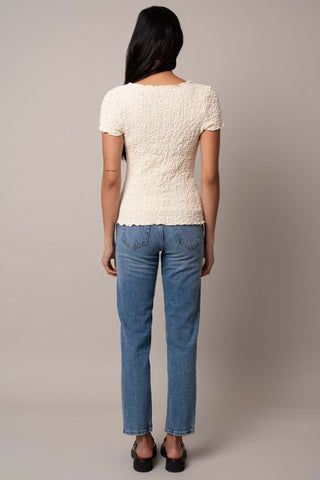 Model is wearing the Short Sleeve Crinkle Top in Cream.