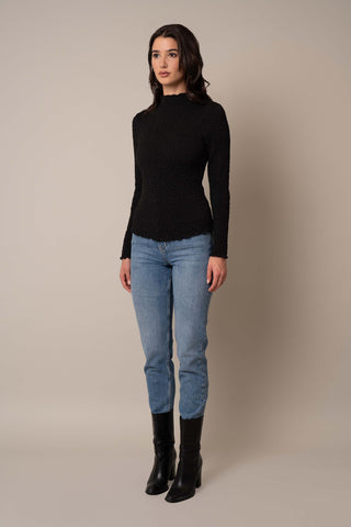 Model is wearing the Long Sleeve Mock Neck Crinkle Top in Black.