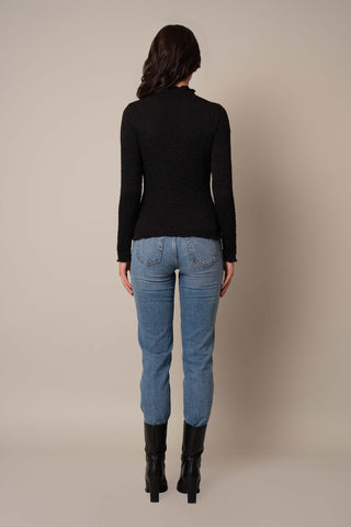 Model is wearing the Long Sleeve Mock Neck Crinkle Top in Black.