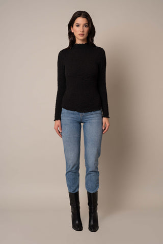 Model is wearing the Long Sleeve Mock Neck Crinkle Top in Black.