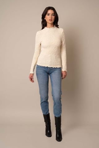 Model is wearing the Long Sleeve Mock Neck Crinkle Top in Cream.