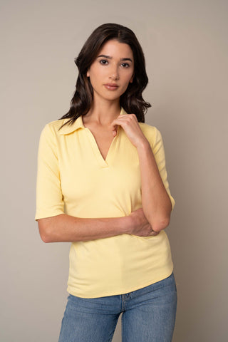 Model is wearing the Ribbed Polo in French Vanilla.