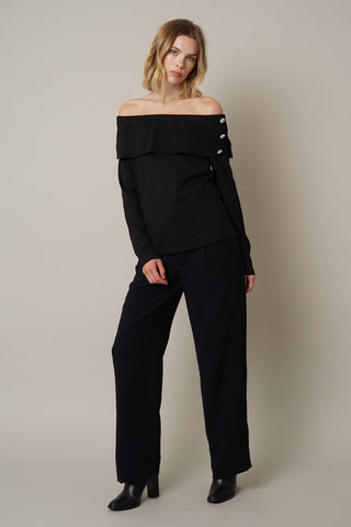 The model is wearing an off-the-shoulder top.